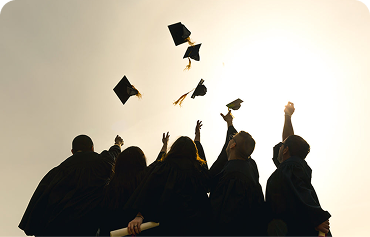 Students throwing graduation caps in the air.